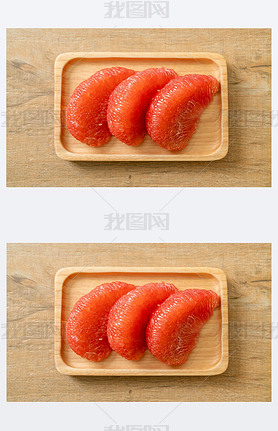 fresh red pomelo fruit or grapefruit on plate