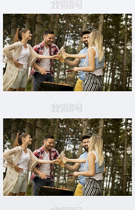 Group of young people enjoying barbecue party in the nature