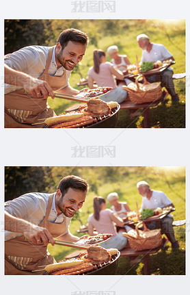 Summertime fun.Man cooking meat on barbecue for summer family lunch in the backyard of the house.