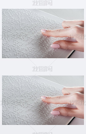 partial view of young woman reading braille text on white paper