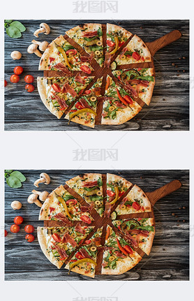 top view of sliced delicious pizza with vegetables and meat on wooden cutting board  