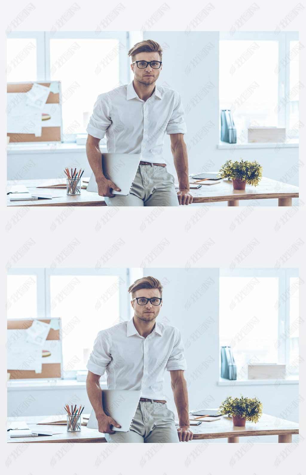 Handsome man in glasses holding laptop 