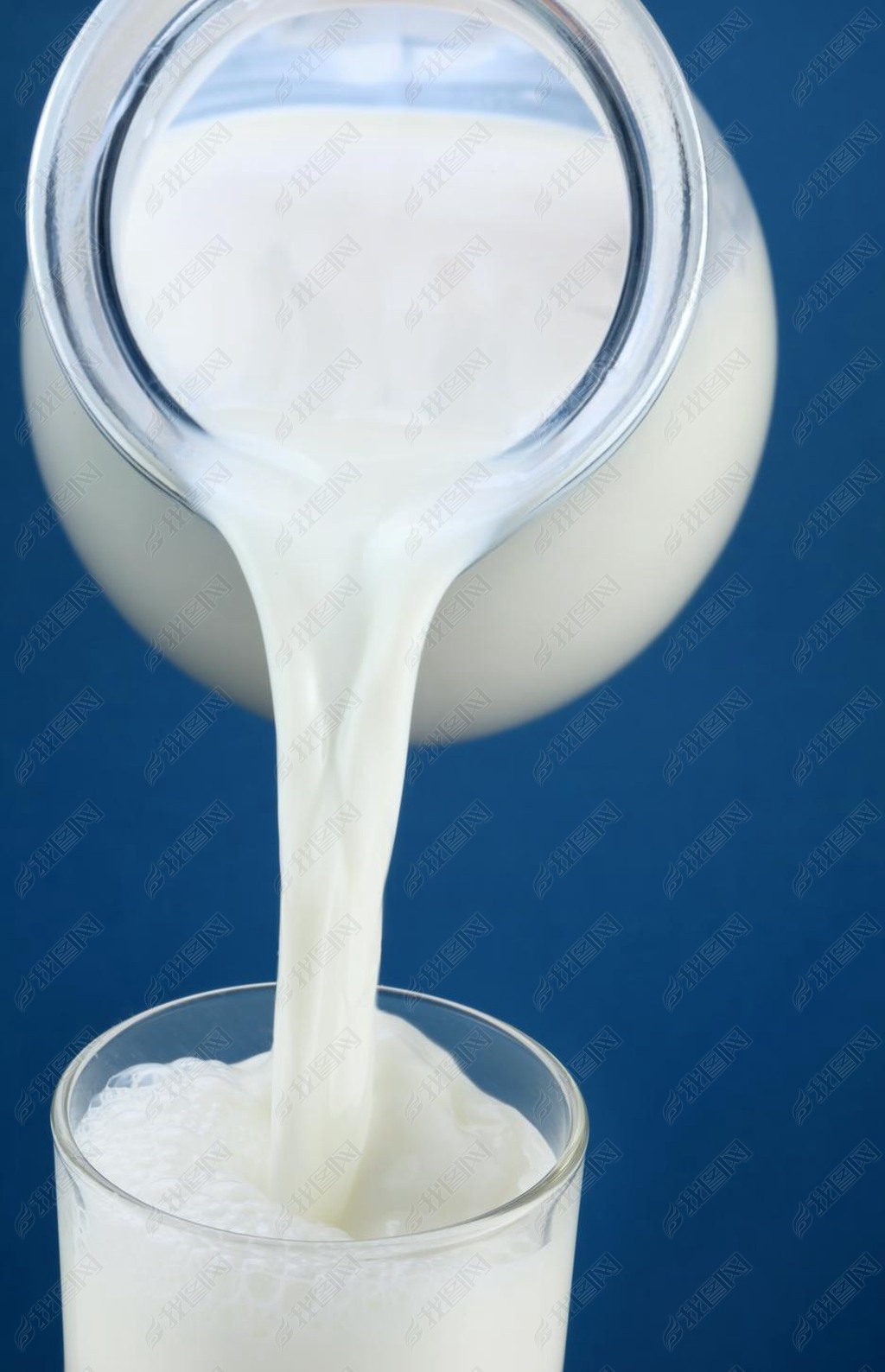 Milk pouring from jar into the glass