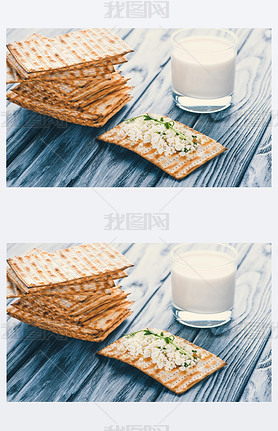 close-up view of crackers with cottage cheese and glass of milk on wooden table 