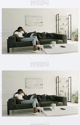 thoughtful african american freelancer sitting on sofa with laptop in spacious living room