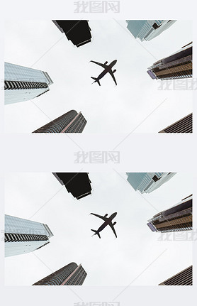 bottom view of skyscrapers and clear sky with airplane in new york city, usa