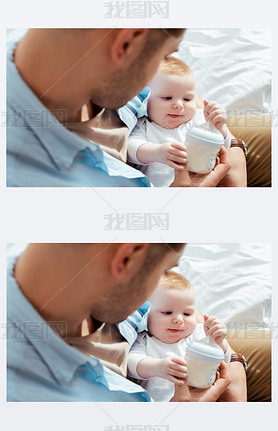 selective focus of cute baby boy touching bottle with milk in fathers hands