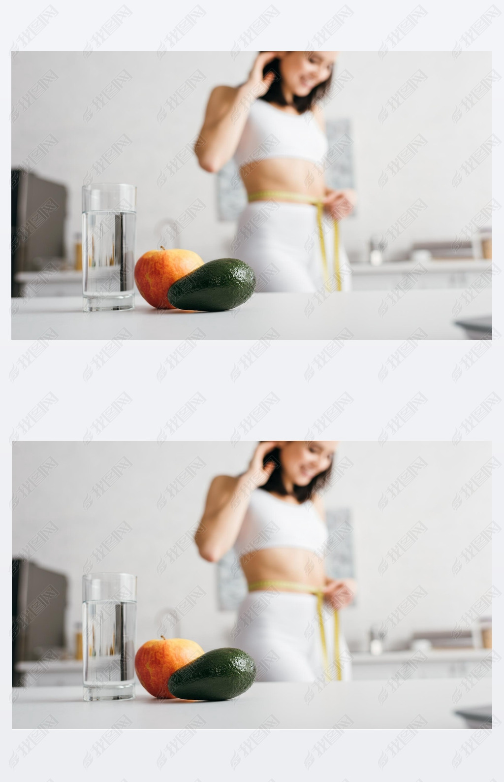 Selective focus of glass of water and fruits on table and iling sportswoman measuring waist with t