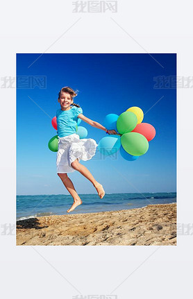 Child playing with balloons at the beach