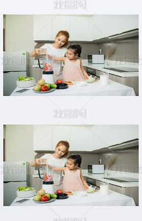 Young Asian mother and daughter making freshly squeezed tomato oothies, daughter is very happy