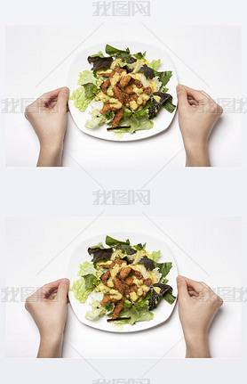 Woman hand hold a dish with salad on the white table.