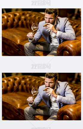 Man tasting wine and oking cigar