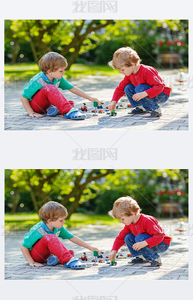 Two little boys playing with car toys