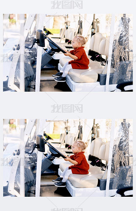 Cute 2-year old is sitting in the drivers seat of a golf cart