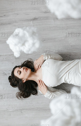 Picture of a girl lying on the floor in the clouds
