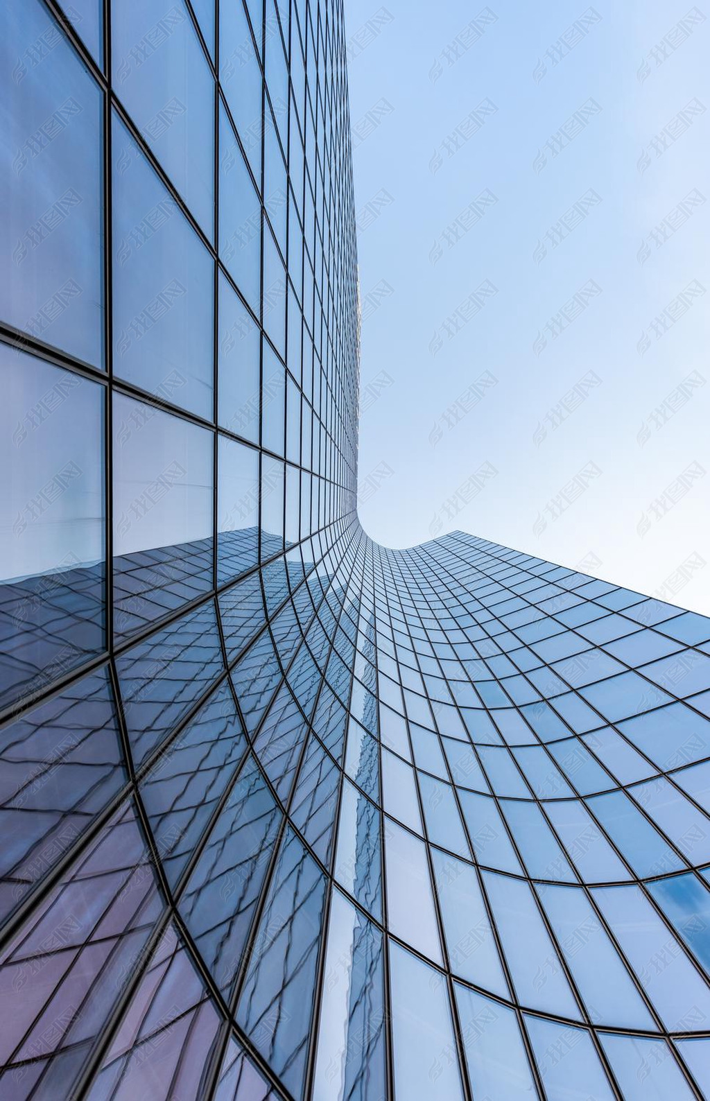 Blue curved glass skyscraper facade against sky