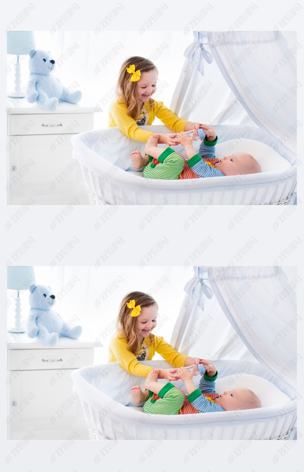 Little girl giving baby brother bottle with milk