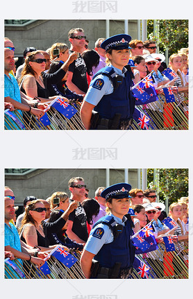 New Zealand police officer woman guarding crowd of people