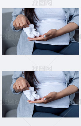 原创孕妇抱着小袜子的裁剪视图