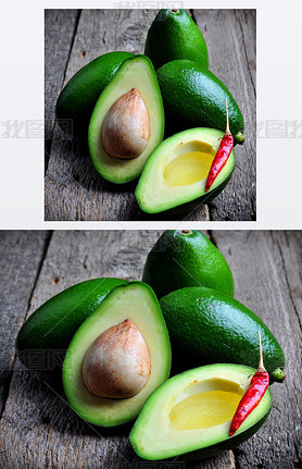 Fresh ocado with olive oil and chili pepper on a wooden background