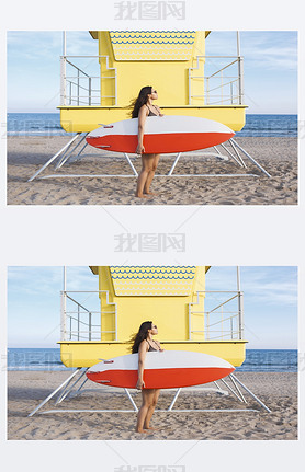 Woman standing with surfboard near the lifeguard house