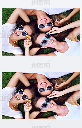 three hipster women laying on the grass