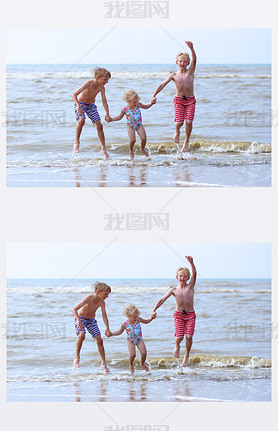 Kids hing fun on the beach jumping over the wes