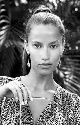 Portrait of beautiful fashion woman in tropics with black sunglasses. Sexy girl wearing color overal