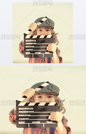 Kid holding clapper board in hands