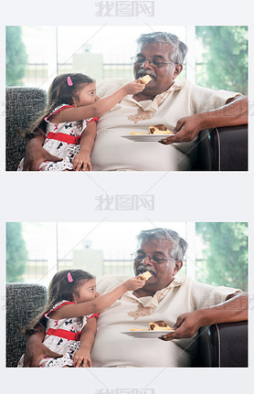 Granddaughter feeding grandfather cake