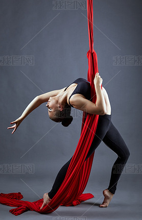 Aerial silk. Pretty young dancer posing at camera