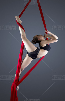 Image of flexible young dancer on aerial silks