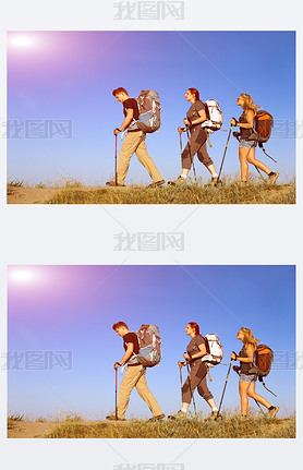 Group of hikers walks on grassy lawn