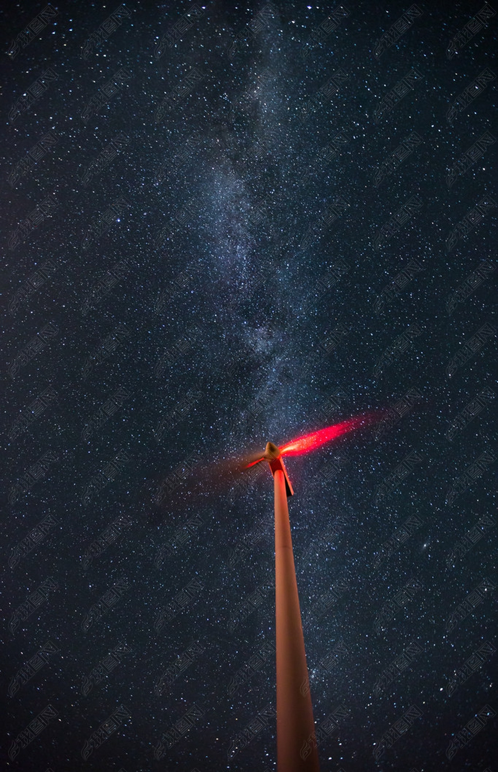 Wind turbines on the starry night sky with milkyway