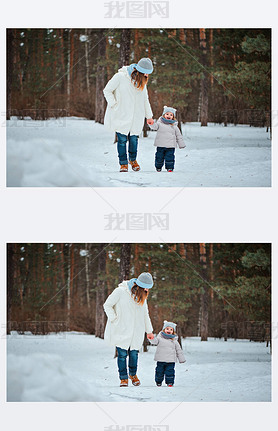 Mother and daughter walking in snowy forest