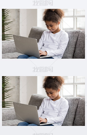 Curious preschool african mixed race girl using laptop on couch, little art black kid typing on co