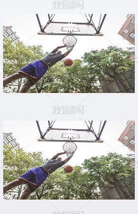 Afro-american basketball player training on a court in New York - Sportive man playing basket outdoo