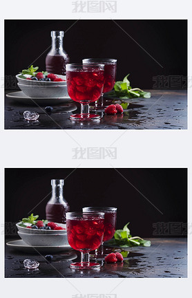 Glasses of a red berry juice on the black table, selective focus