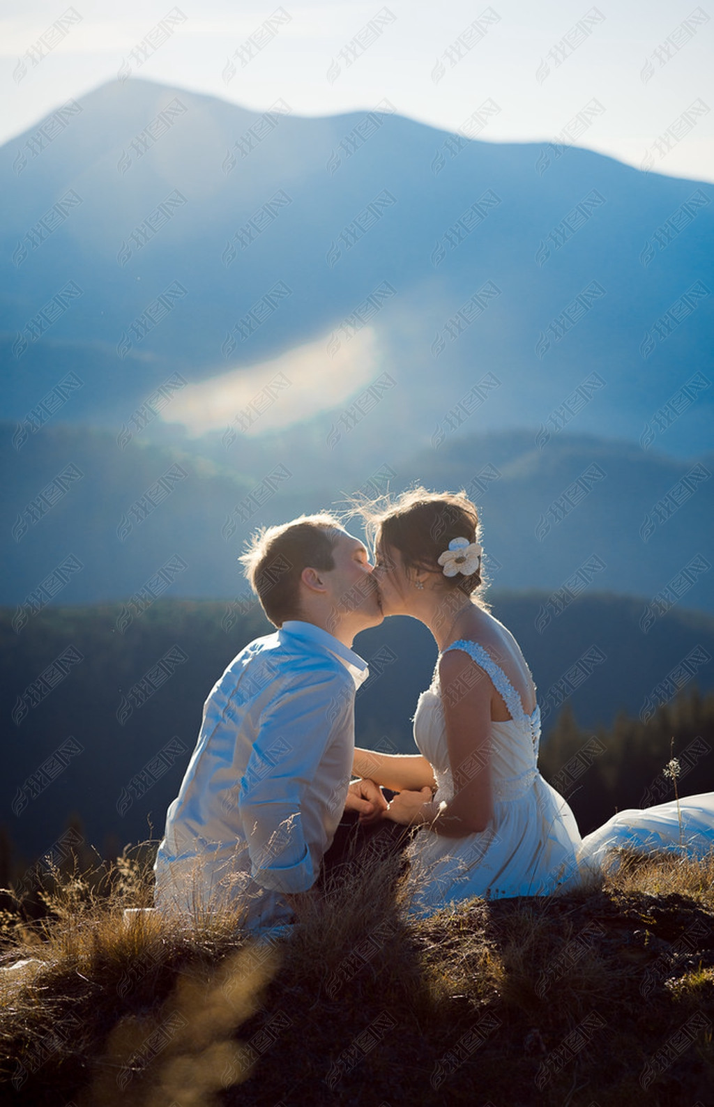 Romantic wedding couple tenderly kiss. Wonderful Alps on background