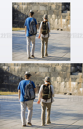 Two beautiful tourists with backpacks in the old town.