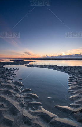 Tranquil colorful sunset over sea, viewed from the dutch coast. The Netherlands