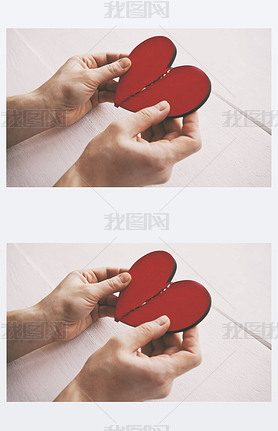 The broken red wooden heart in woman's hands