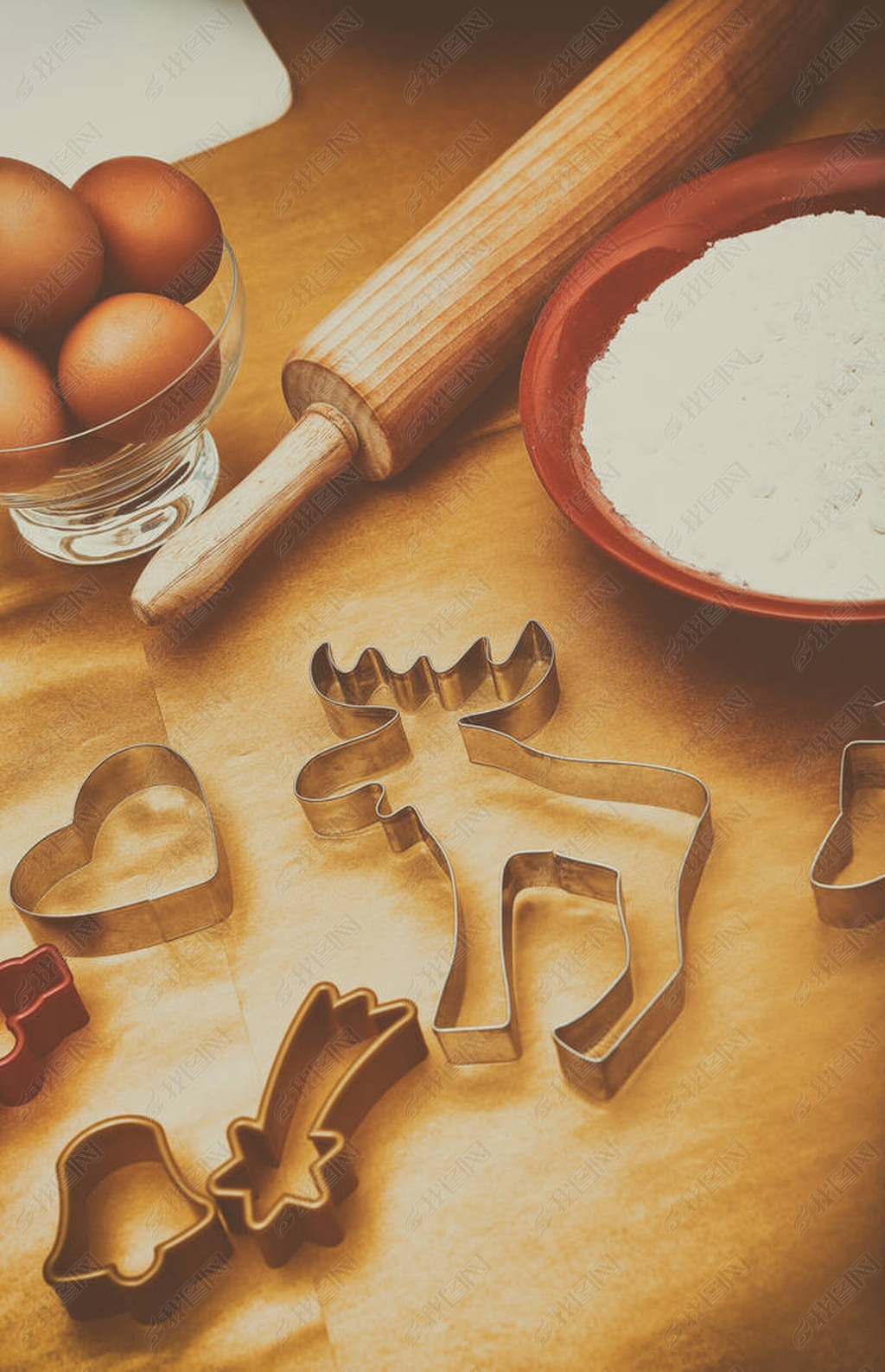 Christmas cookies preparation, different shapes for festive cookies with rolling pin on the wooden t