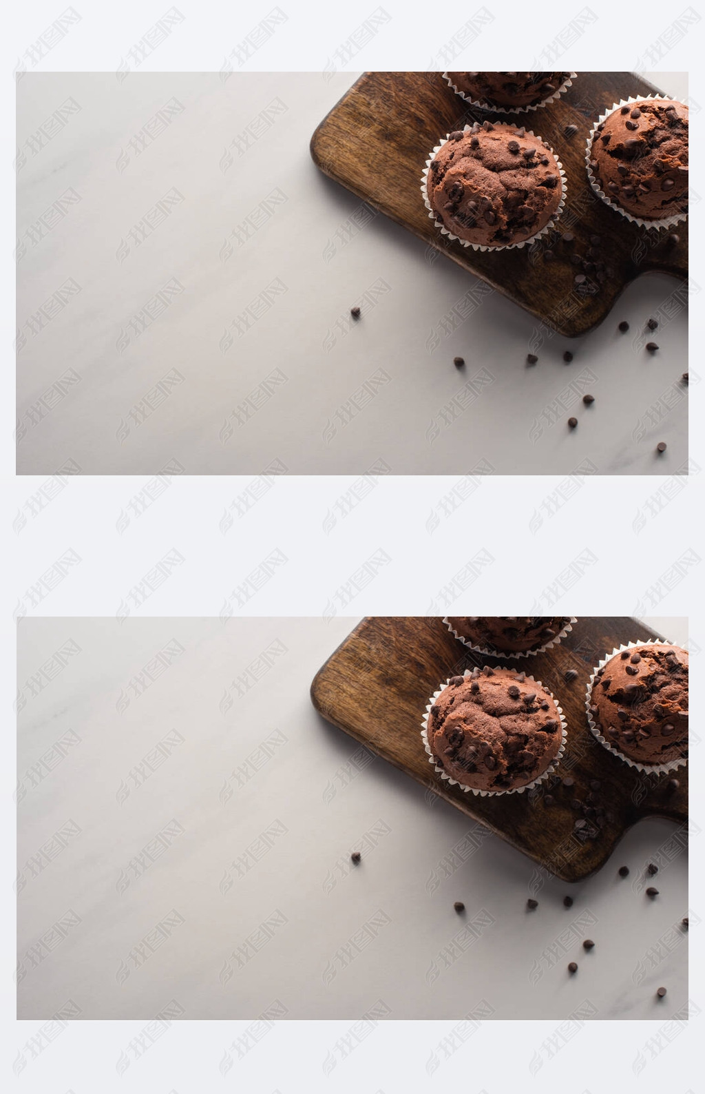 top view of fresh chocolate muffins on wooden cutting board on marble surface