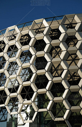 Facade of a modern shopping center. A wall composed of honeycombs hexagons. Contemporary architectur