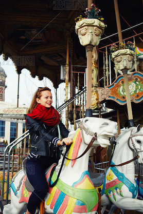 woman riding on a merry go round