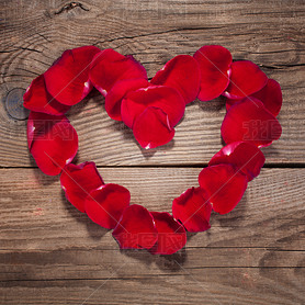 Heart of rose petals on the old wooden boards