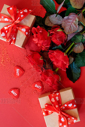 Beautiful bouquet of roses with a gift boxes on a red background, St. Valentine's Day , 8 March and 