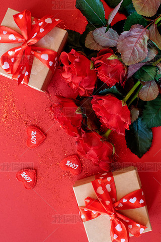 Beautiful bouquet of roses with a gift boxes on a red background, St. Valentine's Day , 8 March and 