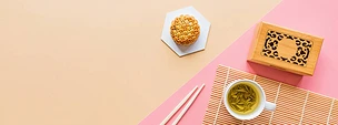 平铺中秋节甜点，中秋节月饼，背景五彩斑斓，绿茶和筷子。顶部视图、复制空间、模型、头顶、模板